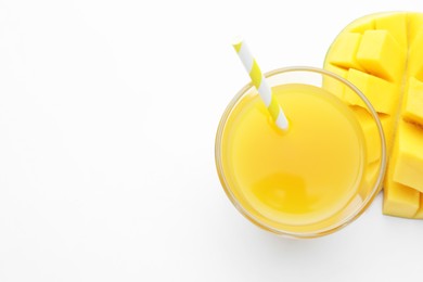 Photo of Tasty mango juice in glass and fresh fruit on white background, flat lay. Space for text