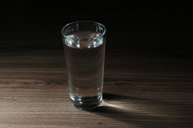 Photo of Fresh water in glass on wooden table