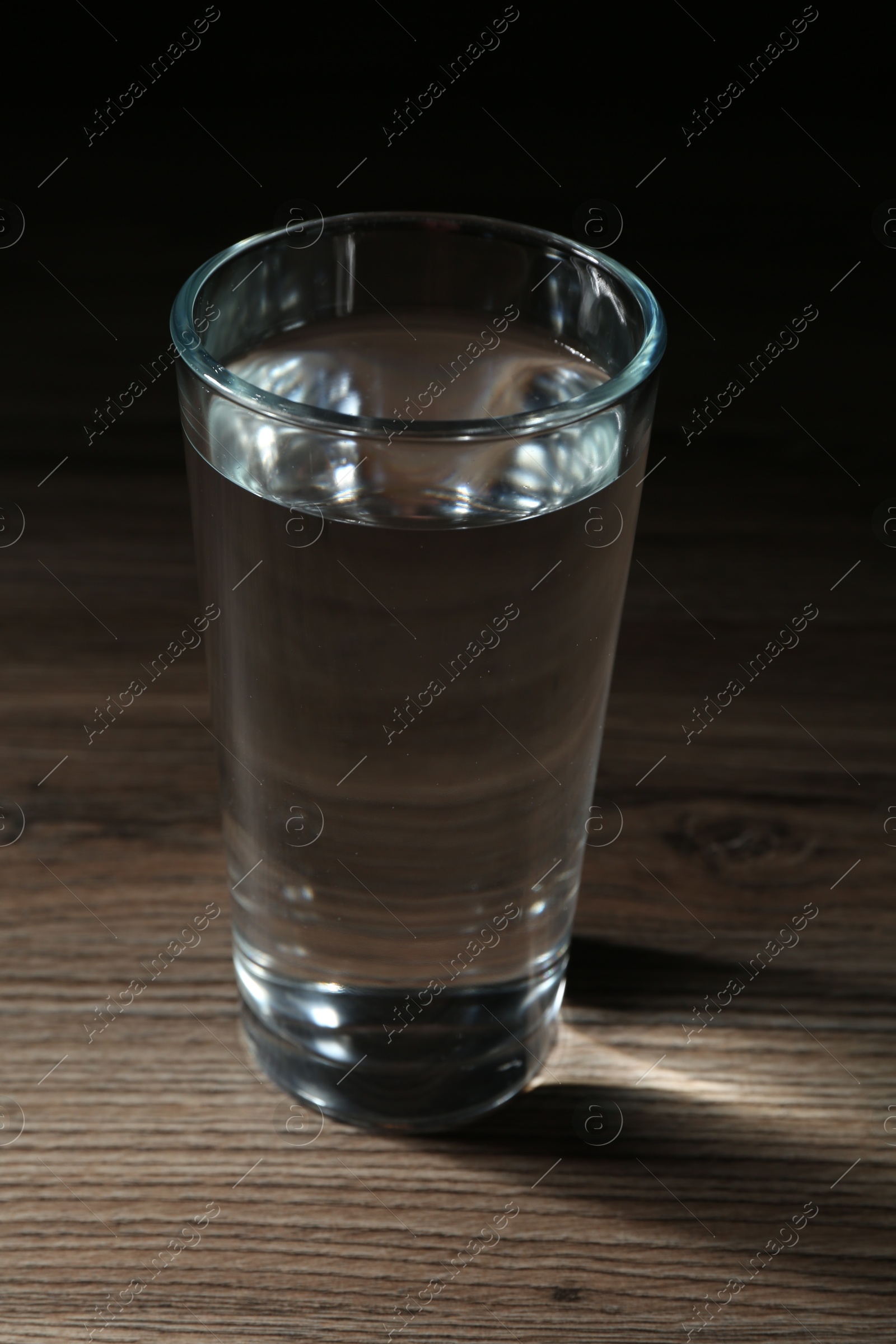 Fresh water in glass on wooden table, closeup Photo of Fresh water in glass on wooden table, closeup
