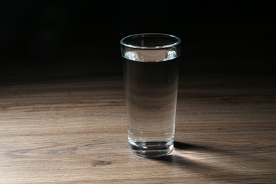 Photo of Fresh water in glass on wooden table