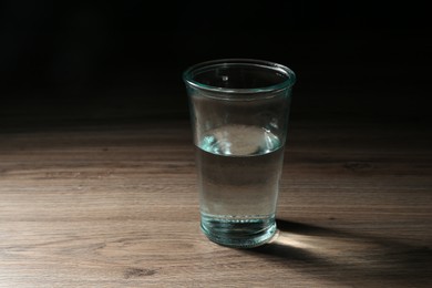 Photo of Fresh water in glass on wooden table
