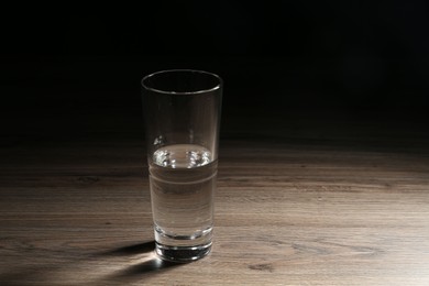 Photo of Fresh water in glass on wooden table
