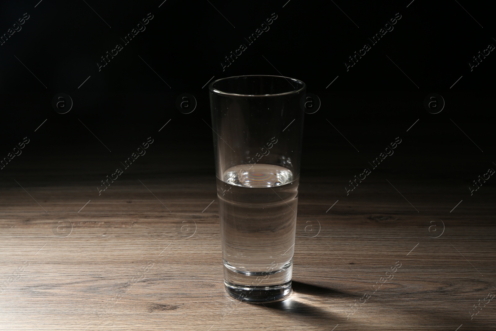 Photo of Fresh water in glass on wooden table