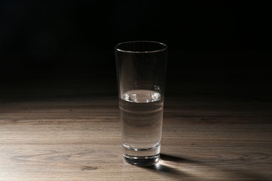Photo of Fresh water in glass on wooden table