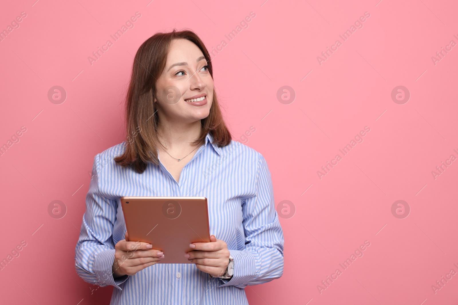 Photo of Woman with modern tablet on pink background, space for text