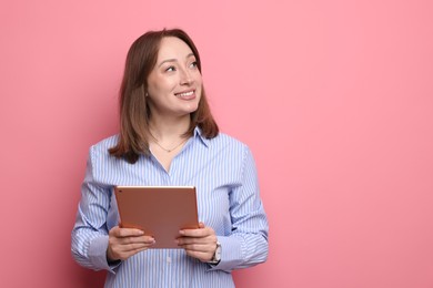 Photo of Woman with modern tablet on pink background, space for text