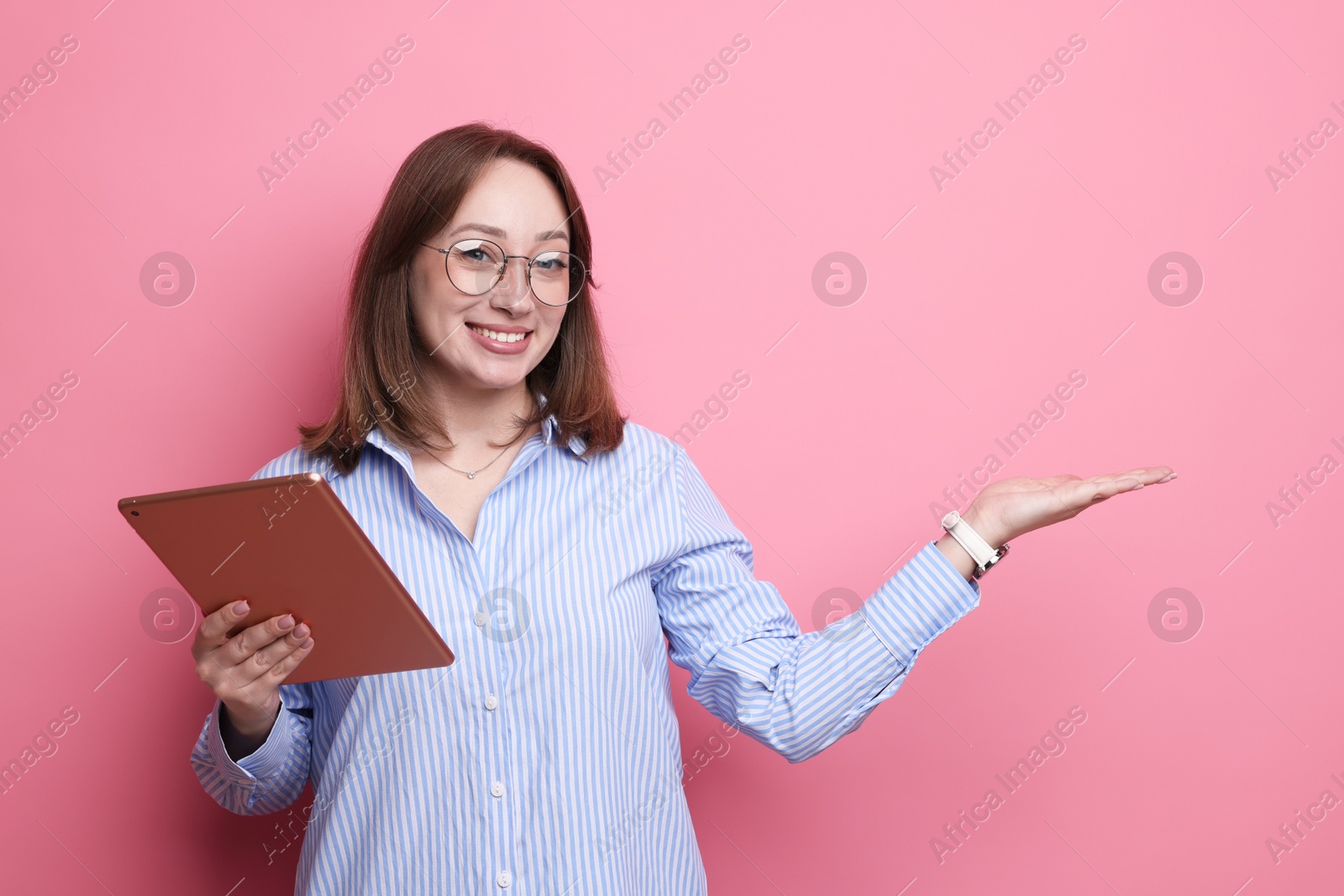 Photo of Woman with modern tablet on pink background. Space for text