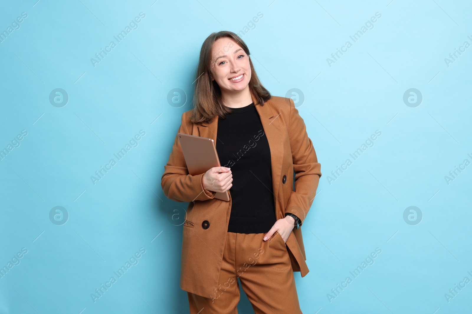 Photo of Woman with modern tablet on light blue background