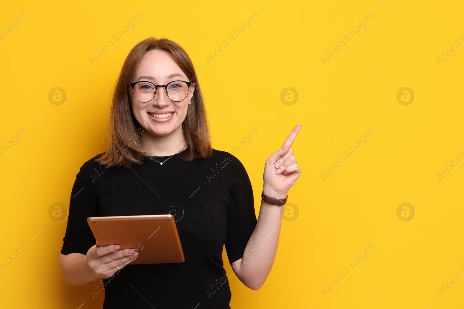 Photo of Woman with modern tablet on orange background, space for text