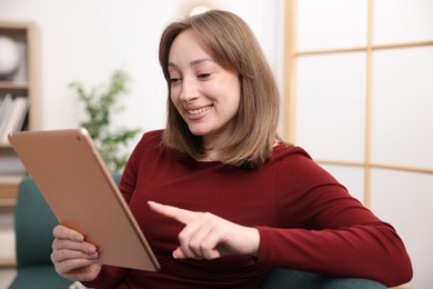 Photo of Woman with modern tablet on sofa at home