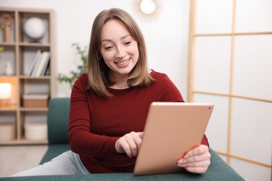 Photo of Woman with modern tablet on sofa at home