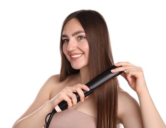 Photo of Woman straightening her beautiful hair on white background