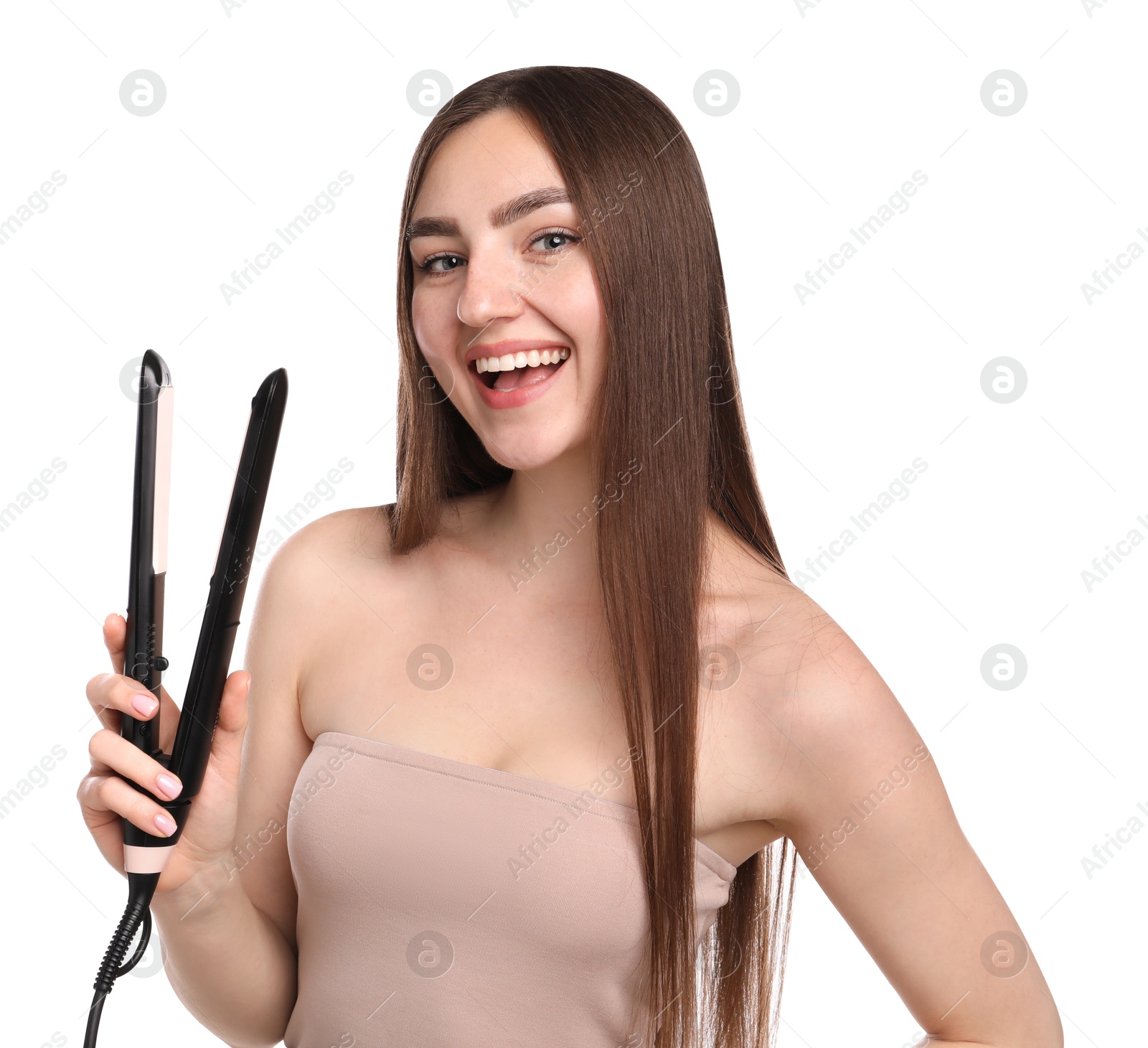 Photo of Woman straightening her beautiful hair on white background