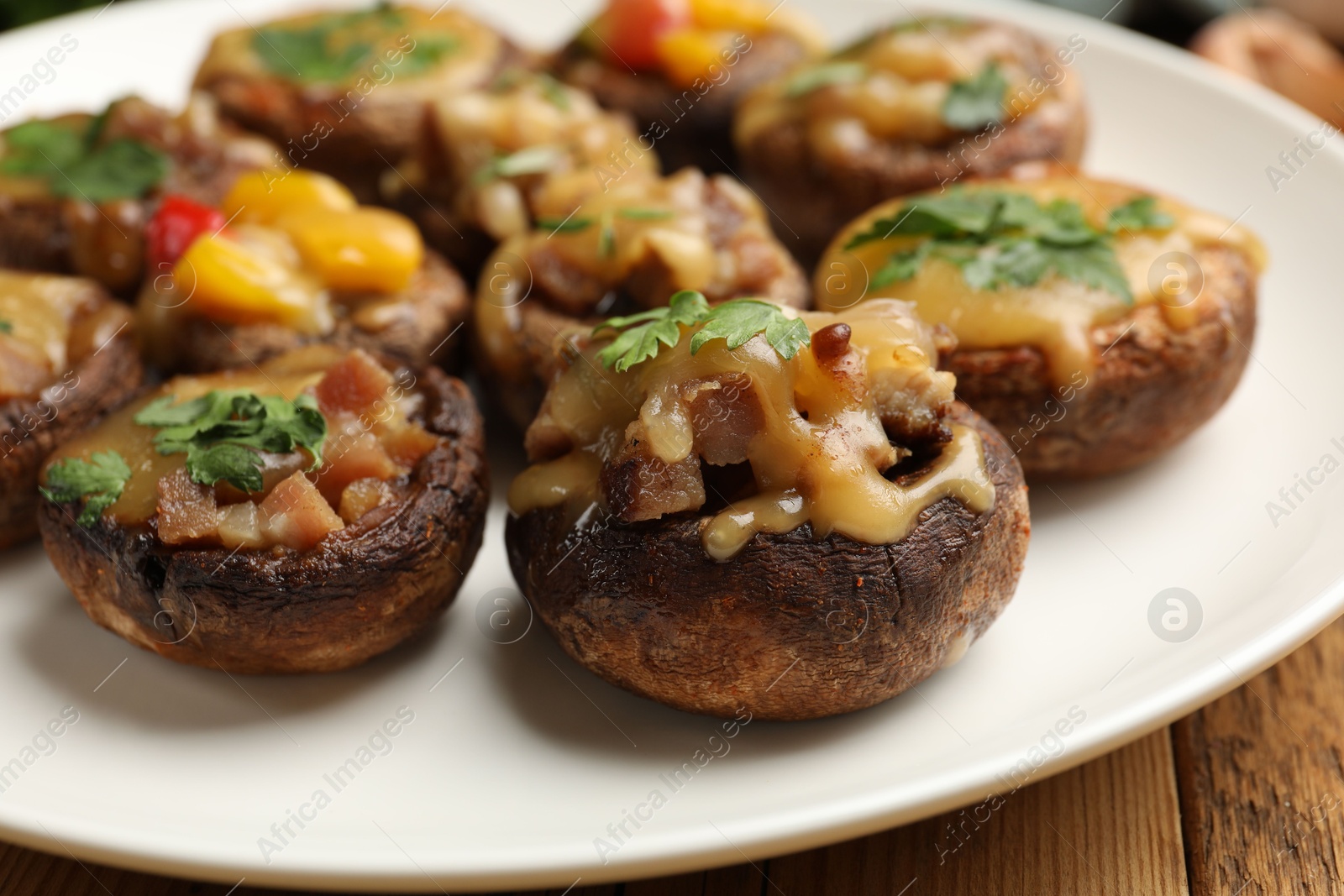 Tasty stuffed mushrooms on wooden table, closeup Photo of Tasty stuffed mushrooms on wooden table, closeup