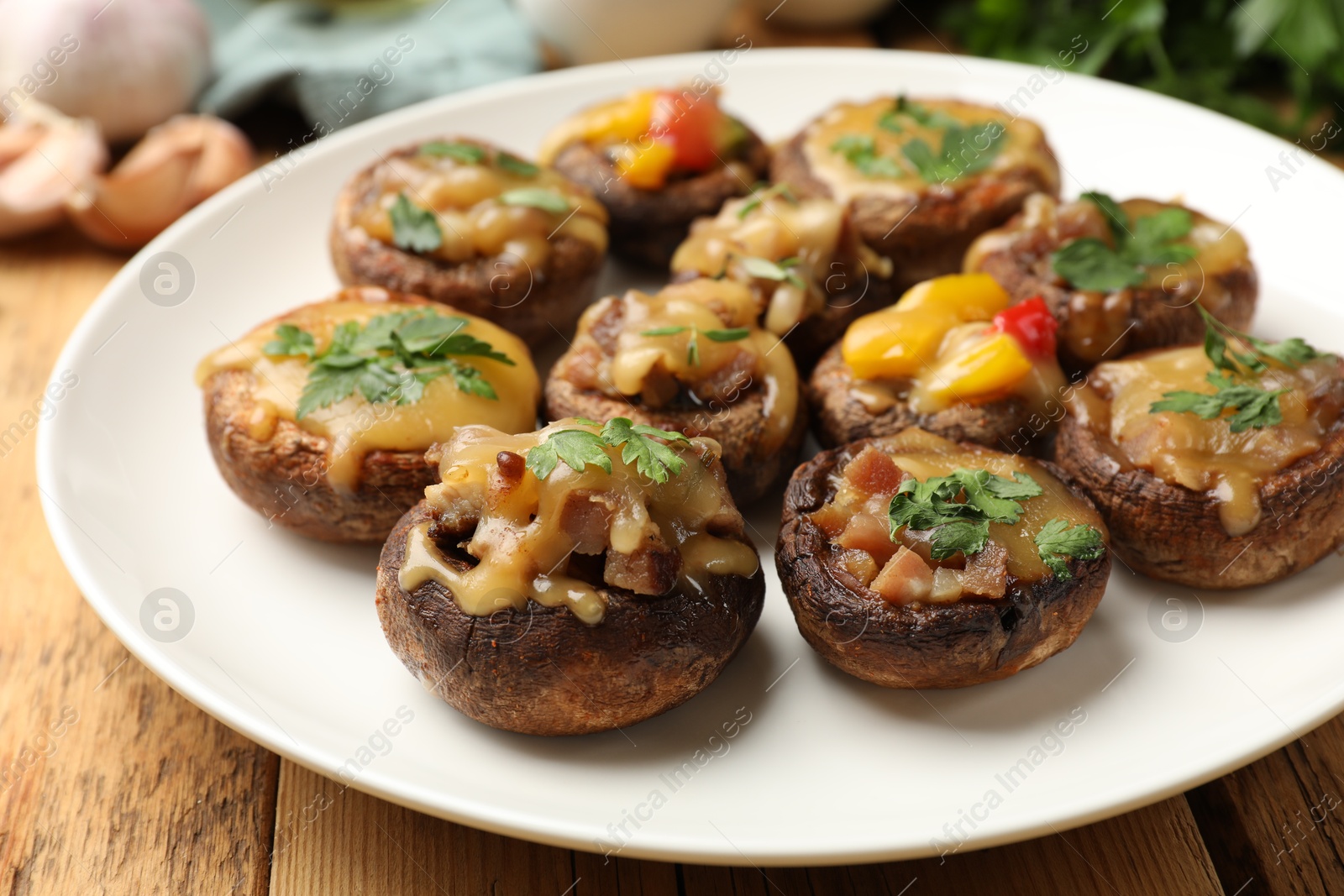 Tasty stuffed mushrooms on wooden table, closeup Photo of Tasty stuffed mushrooms on wooden table, closeup