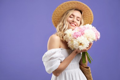Photo of Happy woman with bouquet of beautiful peonies on purple background, space for text