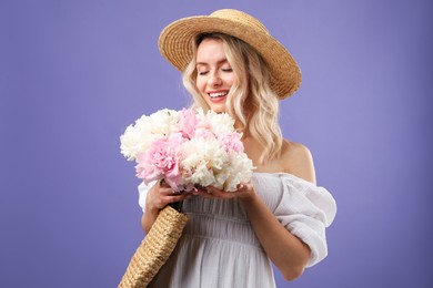 Photo of Happy woman with bouquet of beautiful peonies on purple background