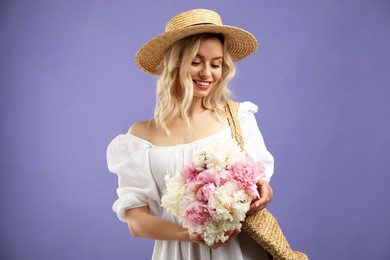 Photo of Happy woman with bouquet of beautiful peonies on purple background