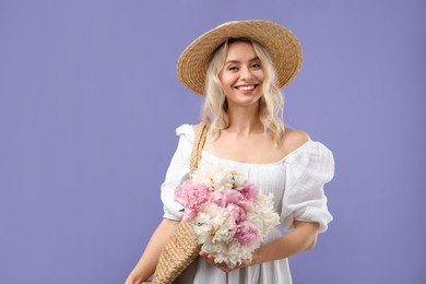 Photo of Happy woman with bouquet of beautiful peonies on purple background