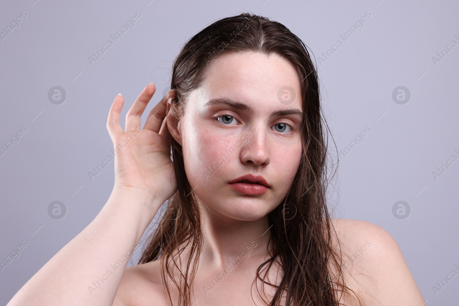 Photo of Portrait of woman with natural skin complexion on grey background, closeup