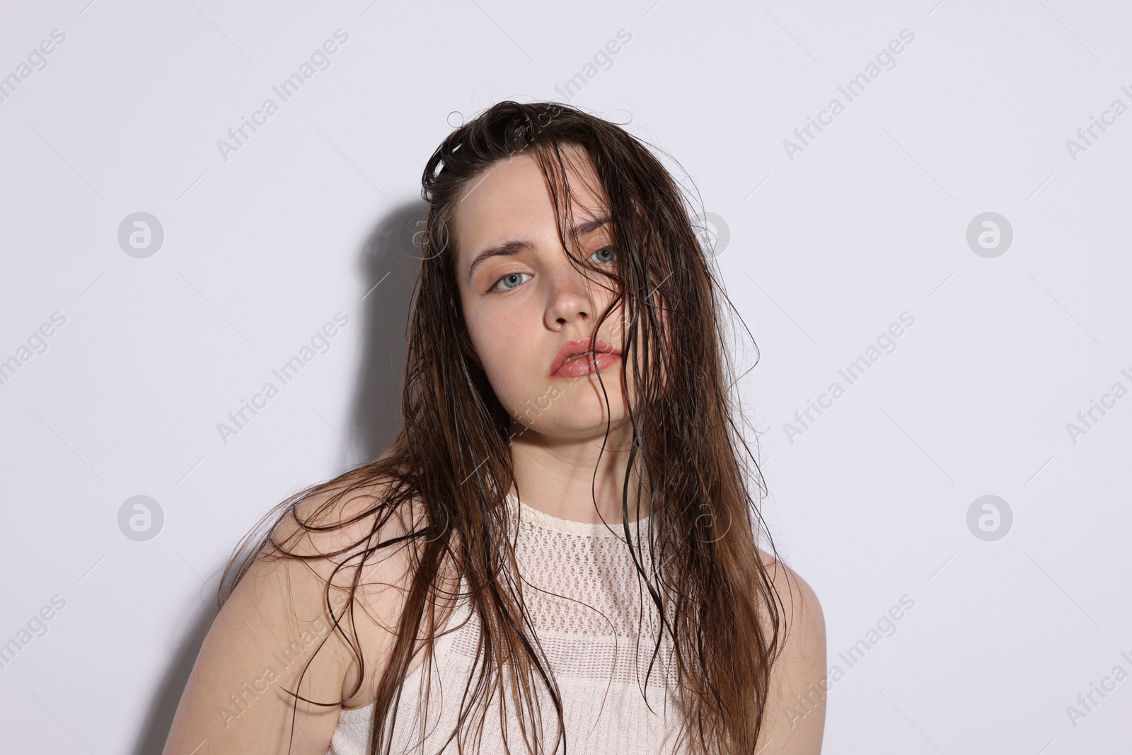 Photo of Portrait of beautiful woman with natural skin complexion on light grey background, closeup