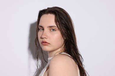 Photo of Portrait of beautiful woman with natural skin complexion on light grey background, closeup