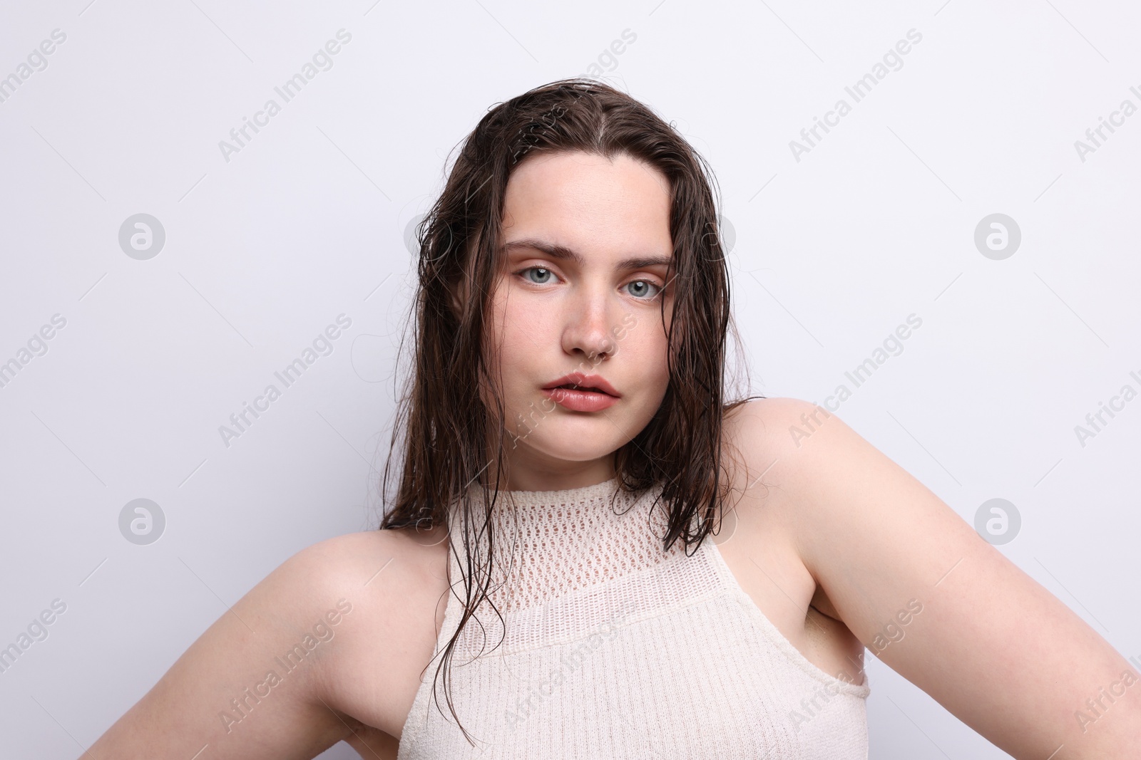 Photo of Portrait of beautiful woman with natural skin complexion on light grey background, closeup