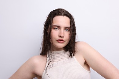 Photo of Portrait of beautiful woman with natural skin complexion on light grey background, closeup