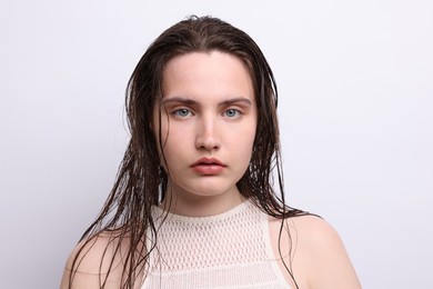 Photo of Portrait of beautiful woman with natural skin complexion on light grey background, closeup