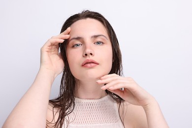 Photo of Portrait of beautiful woman with natural skin complexion on light grey background, closeup