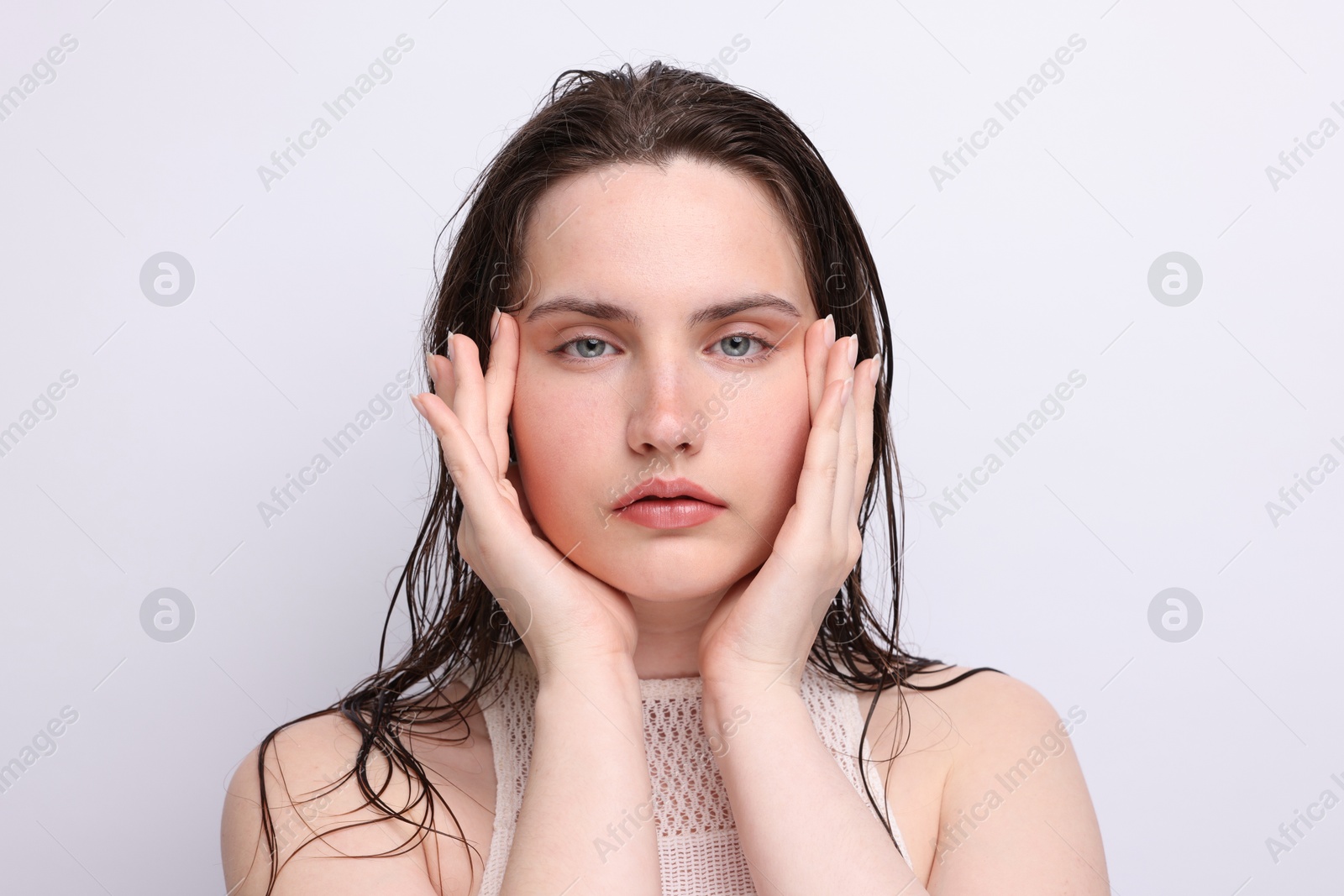 Photo of Portrait of beautiful woman with natural skin complexion on light grey background, closeup