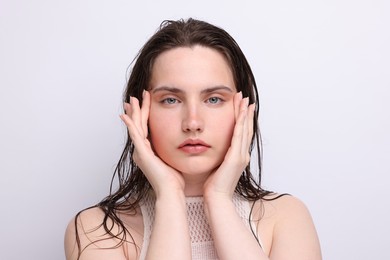 Photo of Portrait of beautiful woman with natural skin complexion on light grey background, closeup