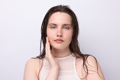 Photo of Portrait of beautiful woman with natural skin complexion on light grey background, closeup