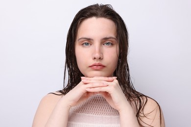 Photo of Portrait of beautiful woman with natural skin complexion on light grey background, closeup