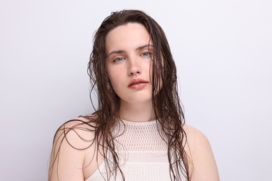 Photo of Portrait of beautiful woman with natural skin complexion on light grey background, closeup