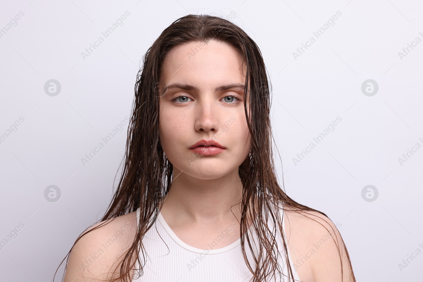 Photo of Portrait of beautiful woman with natural skin complexion on light grey background, closeup
