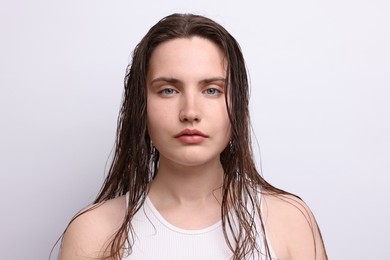 Photo of Portrait of beautiful woman with natural skin complexion on light grey background, closeup