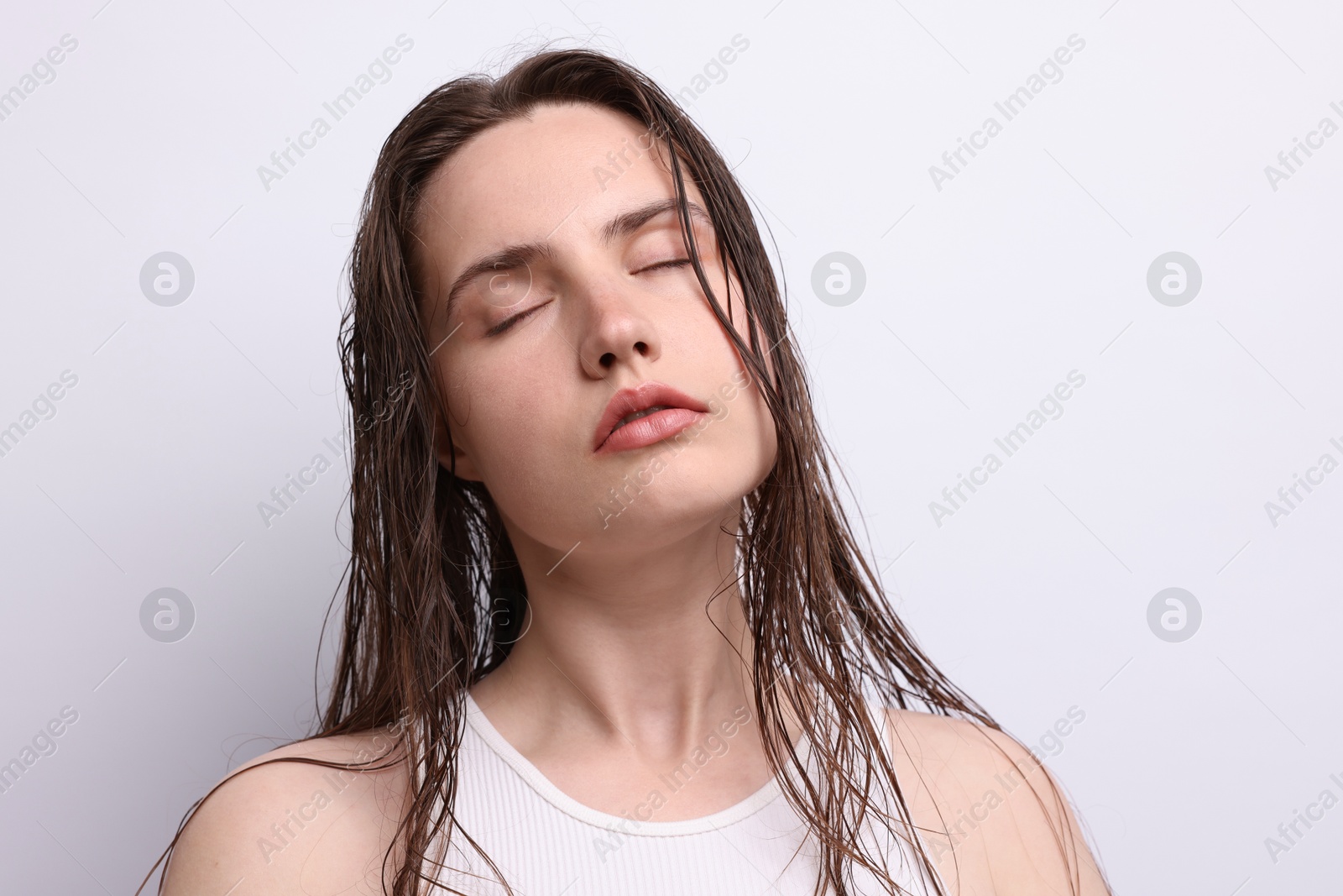 Photo of Beautiful woman with natural skin complexion on light grey background, closeup