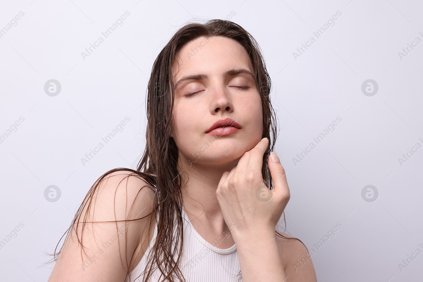 Photo of Beautiful woman with natural skin complexion on light grey background, closeup