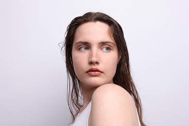 Photo of Beautiful woman with natural skin complexion on light grey background, closeup
