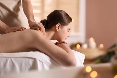Photo of Woman receiving back massage with oil in spa salon, space for text