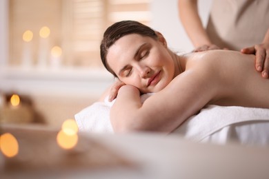 Photo of Woman receiving back massage with oil in spa salon, space for text
