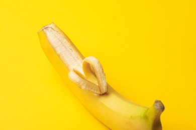 Photo of Banana with heart made of peel on yellow background, closeup
