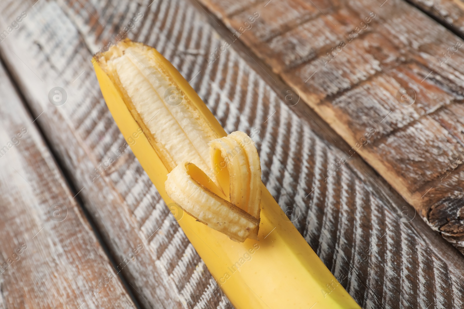 Banana with heart made of peel on wooden table, closeup Photo of Banana with heart made of peel on wooden table, closeup