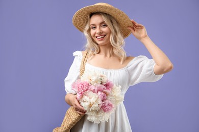 Photo of Happy woman with bouquet of beautiful peonies on purple background