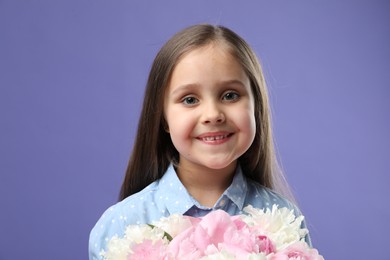 Photo of Cute little girl with bouquet of beautiful peonies on purple background