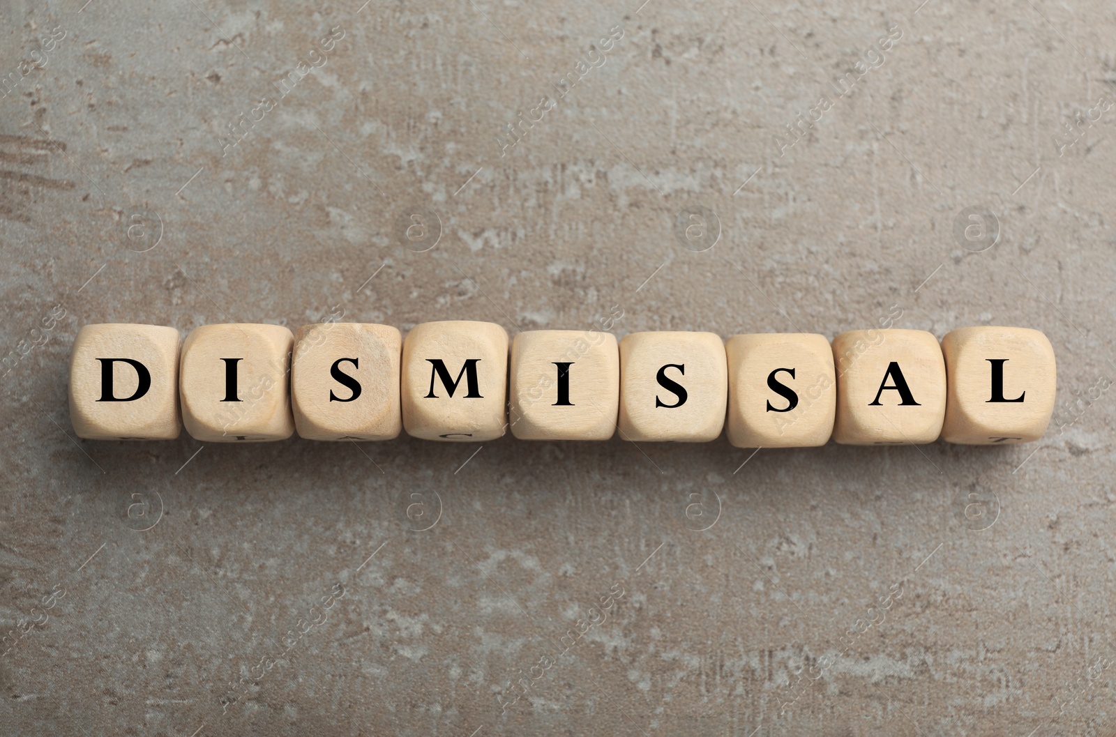 Word Dismissal made of wooden cubes on grey textured background, top view Image of Word Dismissal made of wooden cubes on grey textured background, top view