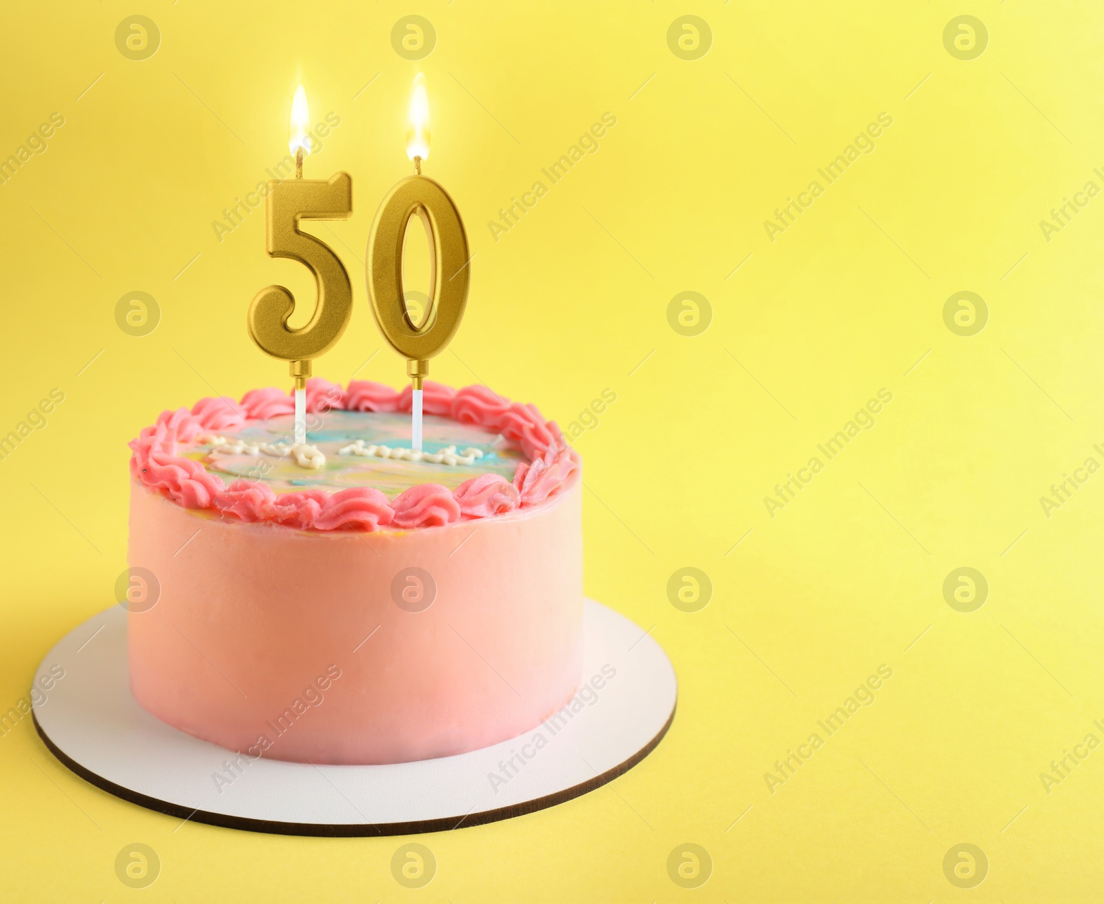 Yummy cake with burning number shaped candles on yellow background, space for text. 50th birthday or other special occasion Image of Yummy cake with burning number shaped candles on yellow background, space for text. 50th birthday or other special occasion