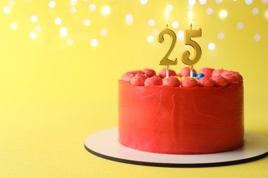 Image of Yummy cake with burning number shaped candles on yellow background with blurred lights, space for text. 25th birthday or other special occasion