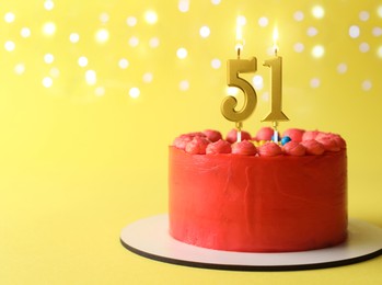 Image of Yummy cake with burning number shaped candles on yellow background with blurred lights, space for text. 51th birthday or other special occasion